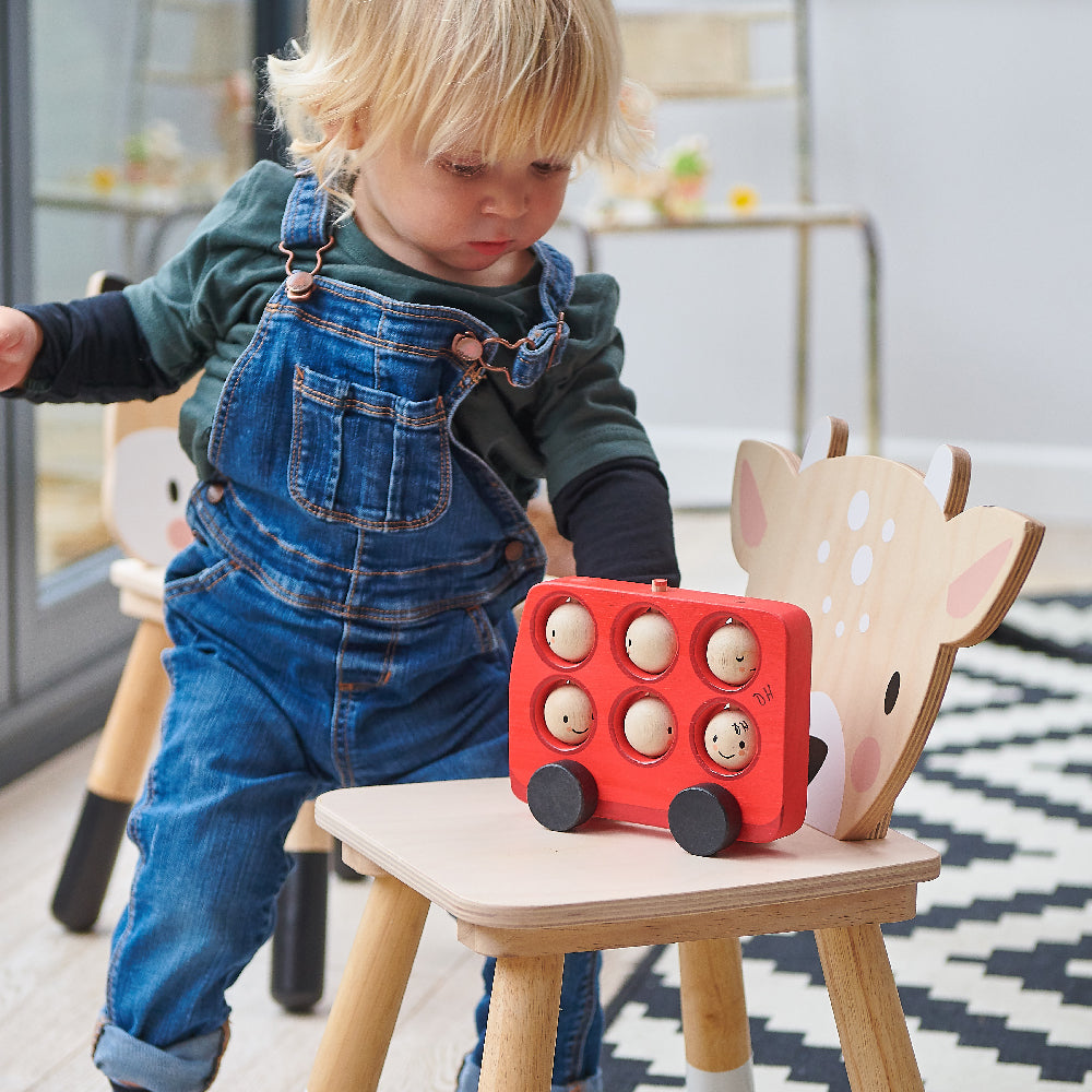 Tender Leaf Toys wooden red bus for toddlers with 6 smiley rotating faces