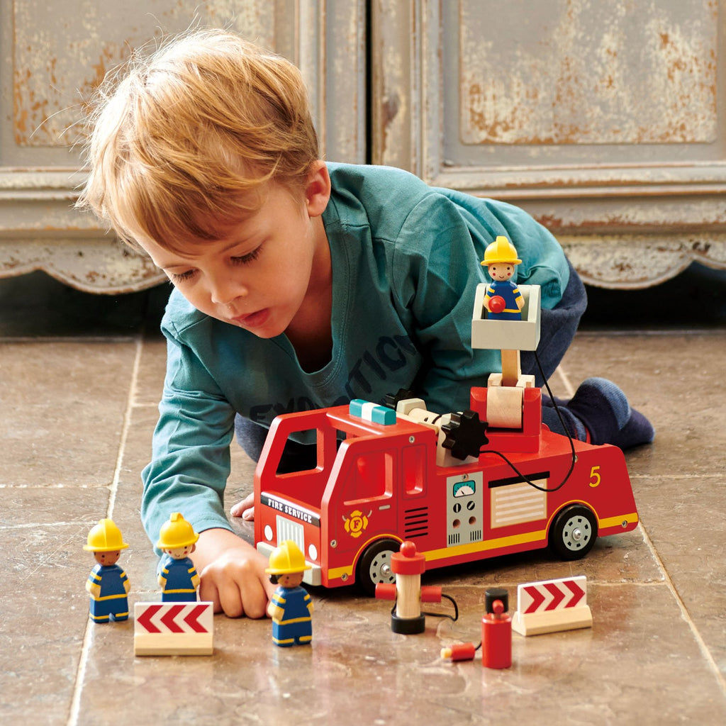 Tender Leaf Toys wooden fire engine in bright red with fire fighter characters