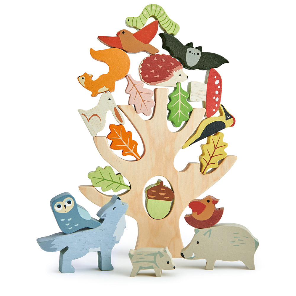tenderleaf toys wooden stacking tree trunk with animals including an owl, a bat, a wolf, a squirrel, a woodpecker, an acorn, a mummy pig with her baby, a caterpillar, five leaves, a toadstool, a moth, a rabbit, a hedgehog, a bird, and a bird in a nest completely plastic free